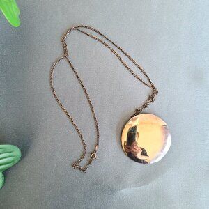 Sterling silver round pendant on silver chain.